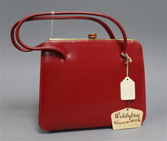 A Waldy bag, a red leather bag and purse in original box